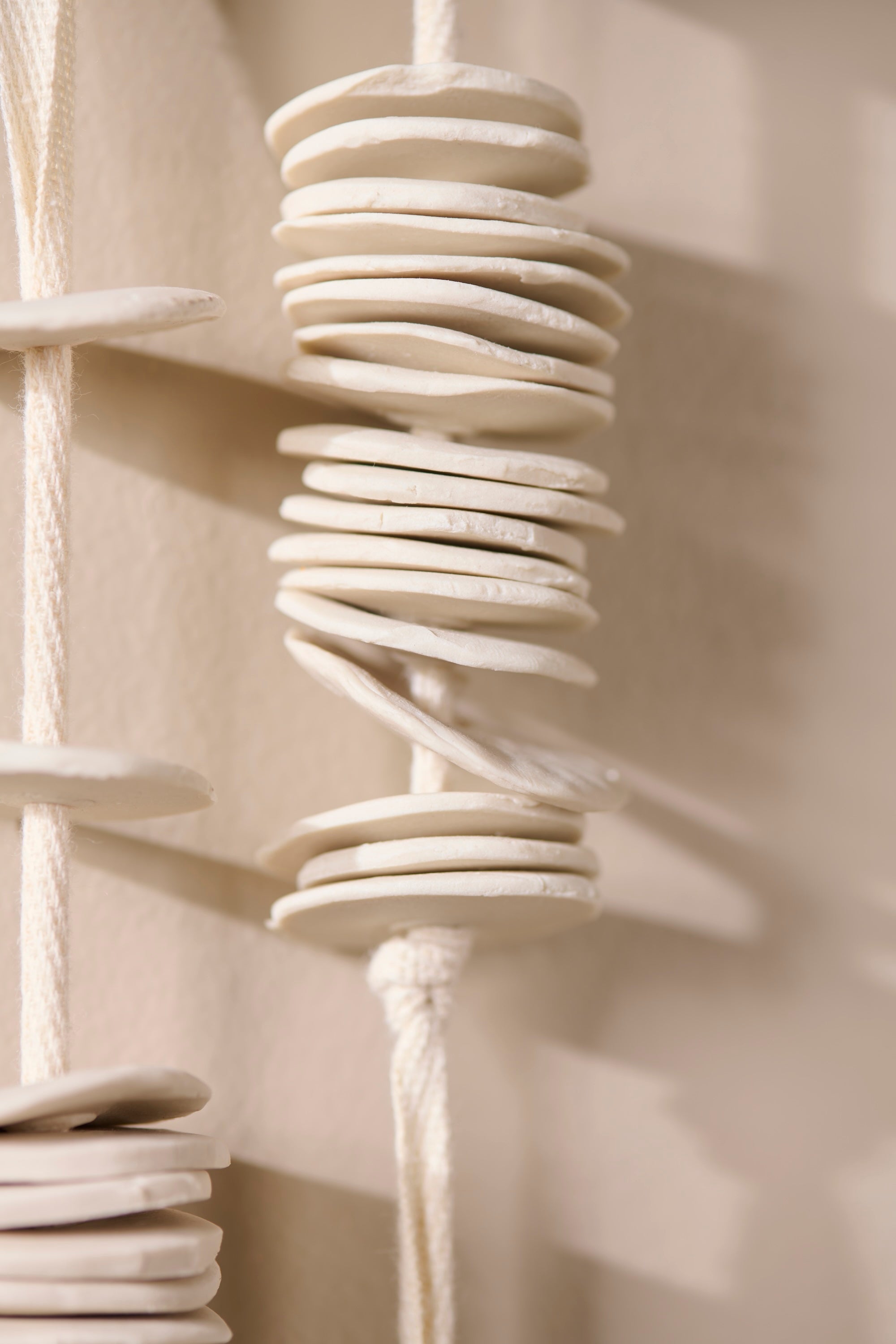 Ceramic discs of the Cadence 1 sculpture revealing fine handmade detail and raw porcelain finish.